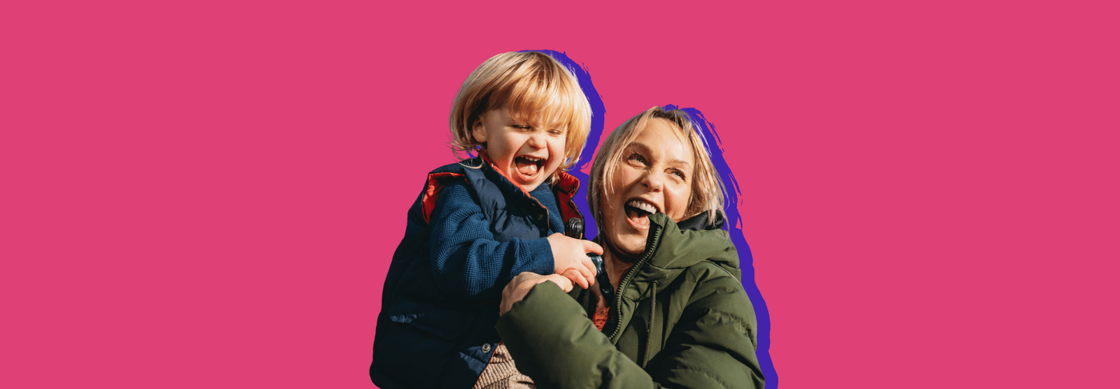 Two smiling children hugging, set against a pink background.