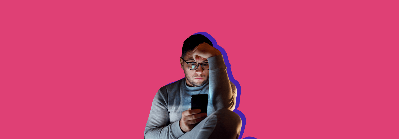 A man in glasses resting a hand on his head while looking at his smartphone, set against a pink background.