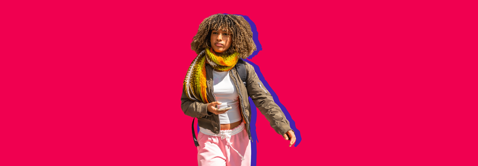 A woman with curly hair and a yellow scarf holding a coffee cup, set against a red background.