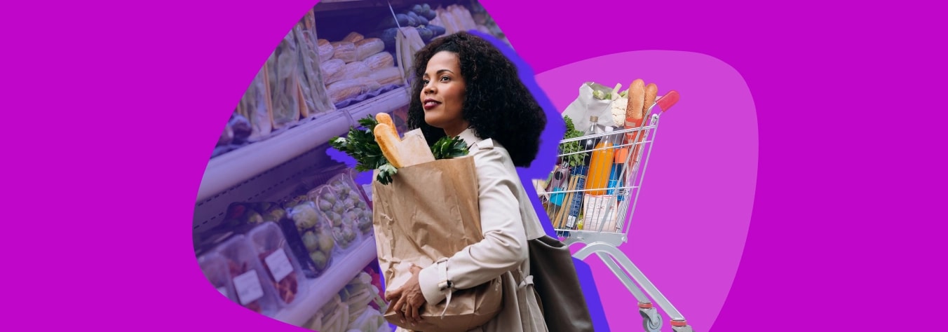 Woman with her arms full of groceries and shopping trolley