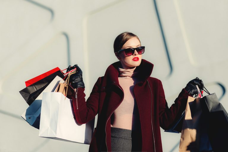 affluent female consumer holding shopping bags.