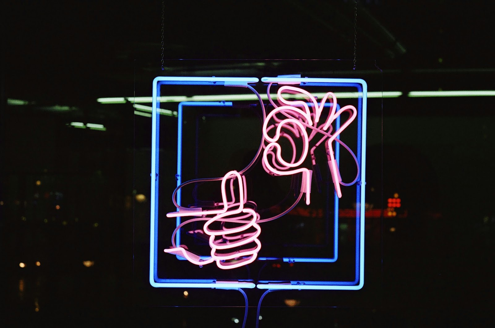 A glowing neon outline of a human brain against a dark background, symbolizing the deep understanding, creativity, and emotional connection behind a great consumer insight.
